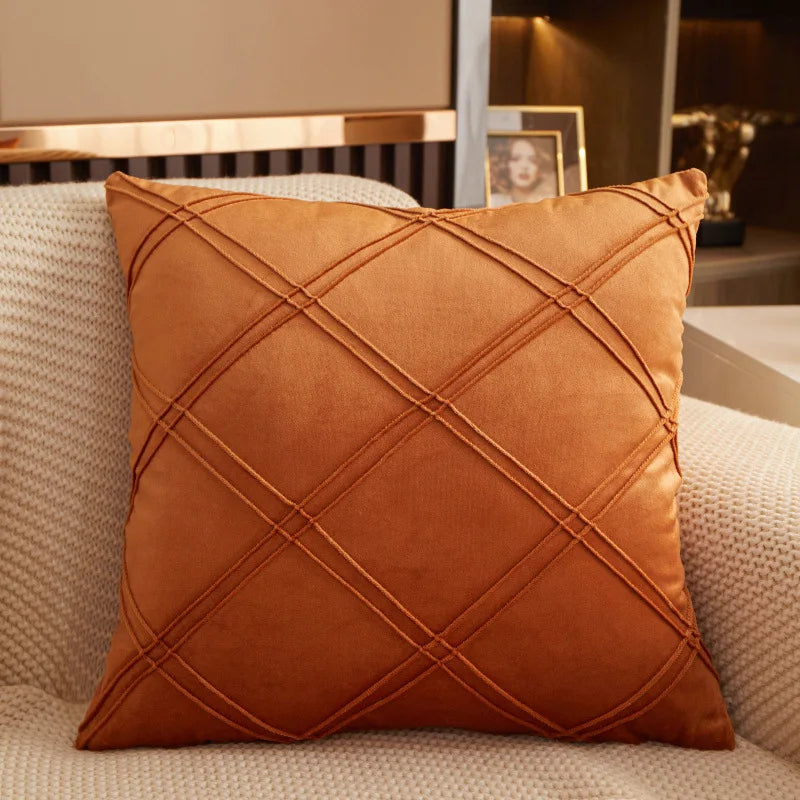 Burnt orange brushed velvet geometric cushion cover on a sofa