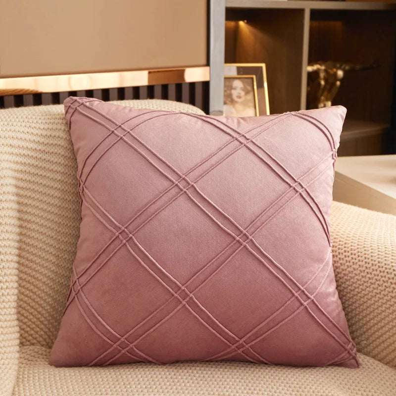 Dusty rose brushed velvet geometric cushion cover on a sofa