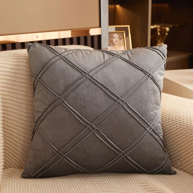 Grey brushed velvet geometric cushion cover on a sofa