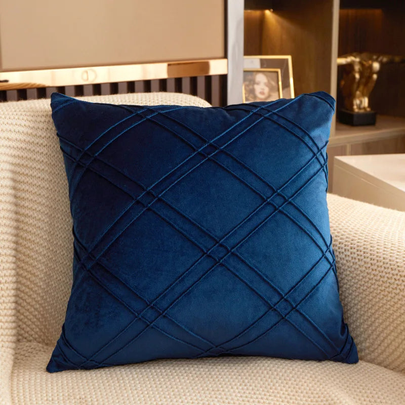 Navy brushed velvet geometric cushion cover on a sofa