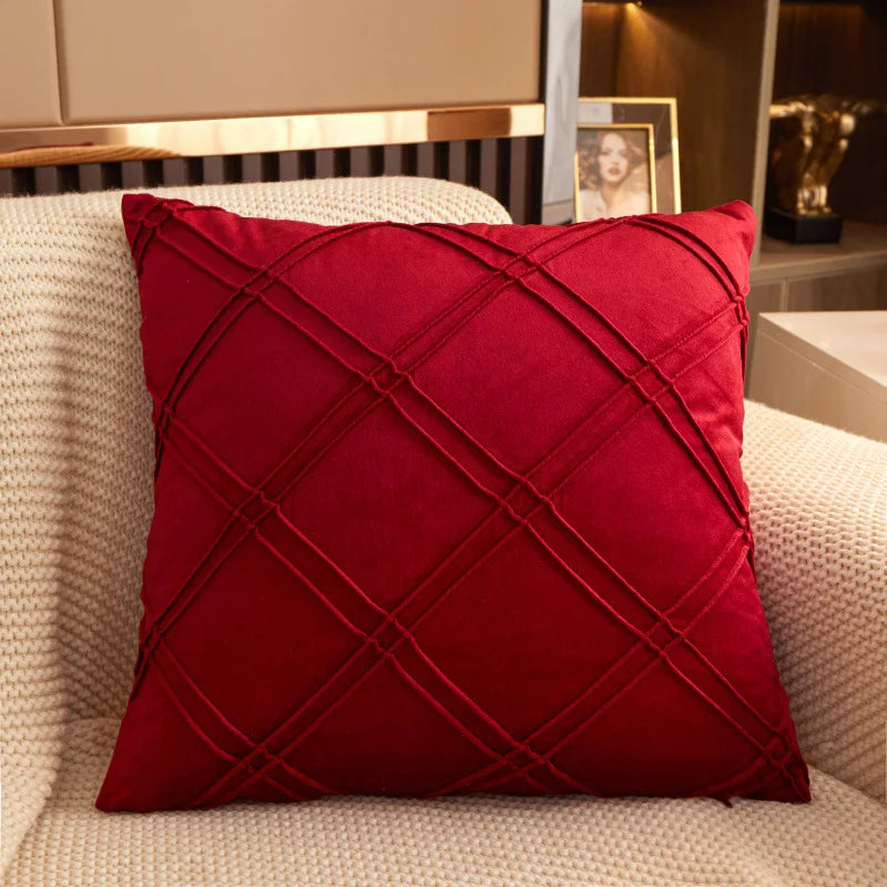 Burgundy brushed velvet geometric cushion cover on a sofa